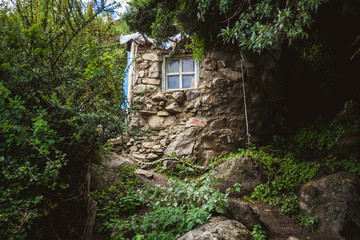 Small stone house in the woods of Chimpu Caves, Tibet, China