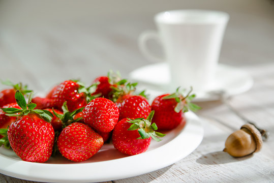 Ripe strawberry fruits on a white plate