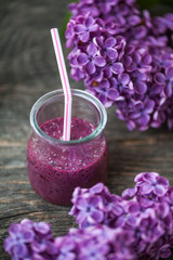 Blueberry smoothie in small glasses on a wooden  table