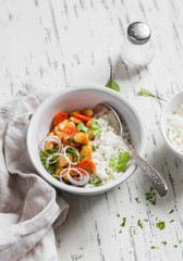 Rice with beans in tomato sauce on a light wooden background. Delicious healthy vegetarian food