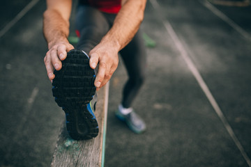 Male runner stretching before workout