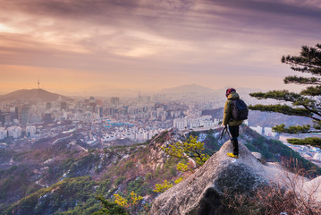 Photographer is taking a picture of sun rises over in Seoul City