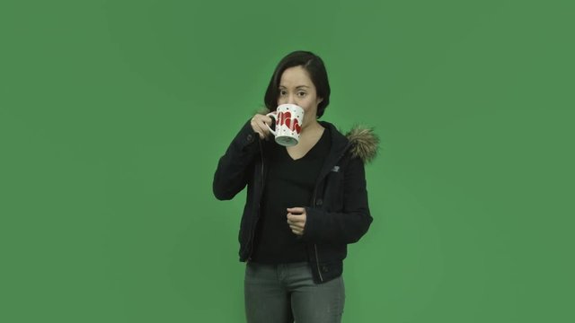 caucasian girl with winter jacket isolated on green screen in love coffee break