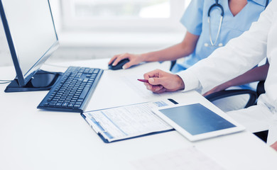 group of doctors looking at tablet pc