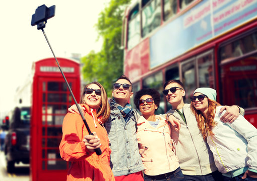 friends taking selfie with smartphone in london