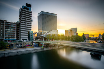 Fototapeta na wymiar Modern district with contemporary buildings near the water channel in Vienna in the morning