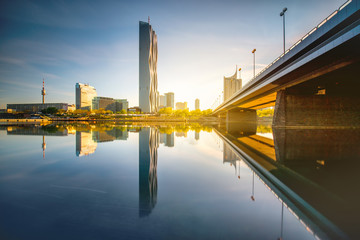 View on Donaucity with bridge in Vienna in the morning. Wide angle image with long exposure technic with glossy water and reflection