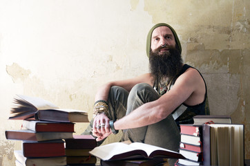 Portrait of a bearded men thinking over books