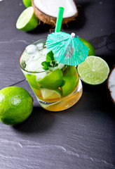 Mojito lime drink on black stone background
