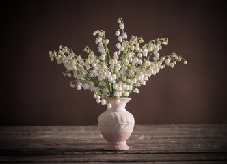 Lilly of valley in  vase on wooden table