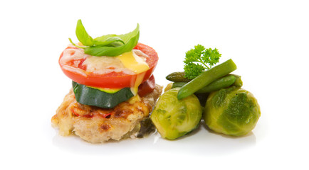 Fried mincemeat baked chops with vegetables and cheese.