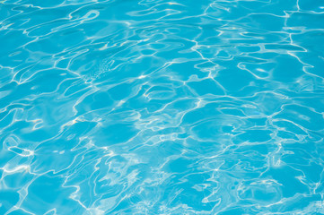 Fototapeta na wymiar Blue water in swimming pool and water surface with sun reflection