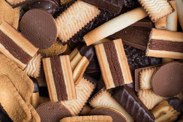 Cookies assorted on black background. Delicious morning snacks for breakfast, brunch and lunch. Appetizing, sweet and fast food.
