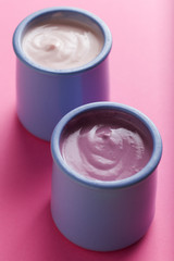 Yogurts assortment  in ceramic bowls on colorful background. Natural and fruit healthy, diet, gourmet dessert for granola breakfast. Sweet yoghurts closeup.