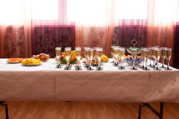 Wedding table with cold snacks and champagne