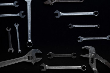 Obraz premium Accessory, assorted tools set on dark background. Construction assortment instruments for repairman, carpenter, builder. Copy space for text. Top view. 