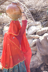 woman carrying drinking water, rural Rajasthan, India