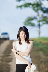 Pretty smiling Asian girl outdoor portrait.