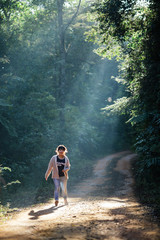 Walking Girl in the natural sunlight and green nature.