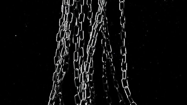 An animated planet Earth is rotating underneath various large metal chains.V1