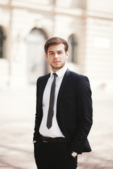 Handsome stylish young businessman posing portrait outdoor