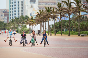 Happy family on bicycles with their feet off the pedals