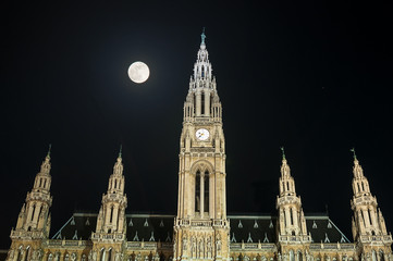 Fototapeta na wymiar City Hall (Rathaus) in Vienna, Austria at night under full moon