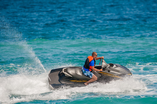 Young Man on Jet Ski, Tropical Ocean, Vacation Concept