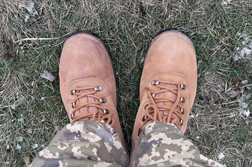 military boots on the colorless dry grass