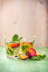 Lemonade drink on a wooden background