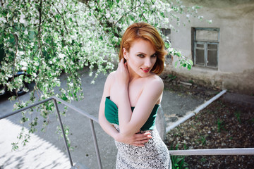 Portrait of a beautiful woman with red hair on the nature