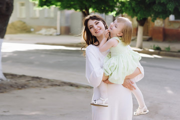 Fototapeta premium Portrait young mother with her daughter on the nature, motherhood, tenderness, childhood, tenderness, lifestyle