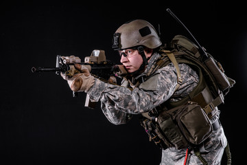 US Marine with gun/US Marine in uniform,helmet, body armor with rifle on black background