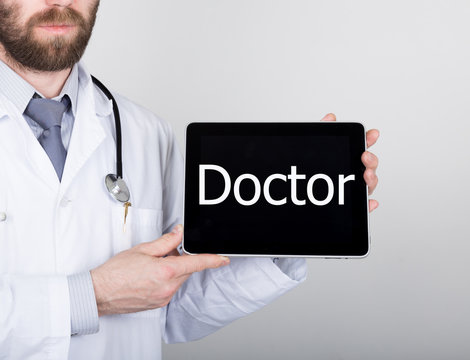 technology, internet and networking in medicine concept - Doctor holding a tablet pc with doctor sign. Internet technologies in medicine