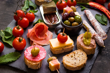 Spanish tapas on a black stone