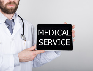 technology, internet and networking in medicine concept - Doctor holding a tablet pc with medical service sign. Internet technologies in medicine