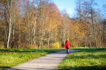 Cute little girl having fun on beautiful autumn day