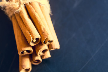 Bunch of cinnamon sticks on black background