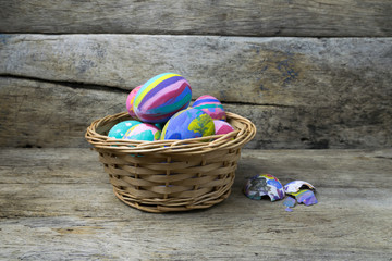Easter eggs in the basket on wooden