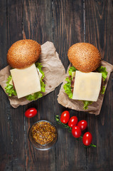 Fototapeta na wymiar Fresh burger closeup on rustic wooden table