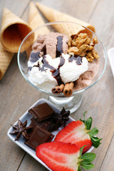 Ice cream sundae, chocolate, walnuts and sliced strawberry