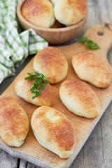 Fresh baked pasties on a chopping board.