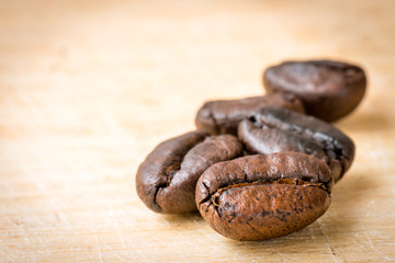 Roasted coffee beans on wooden background, Macro