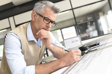 Architect sitting at drawing table in office
