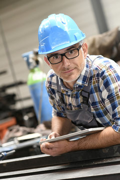 Portrait of engineer using tablet in workshop