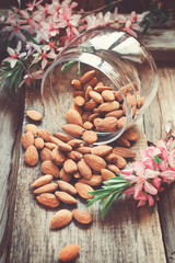 Almond nuts scattered on the banks of the old wooden background,