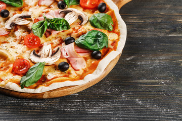 Close-up view of  ITALIAN PIZZA on wooden table. True hot tasty PIZZA with salami, mushrooms, basil, olives, pepper and cheese. Nice for menu Pizzeria. High quality  