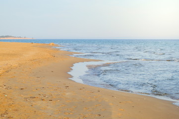 Fototapeta na wymiar Empty beach with calm sea. Summer vacation