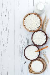 Soft homemade fresh ricotta cottage cheese made from milk, draining on muslin cloth. Tzfat cheese with wheat grains. Symbols of judaic holiday Shavuot.