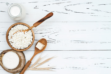 Soft homemade fresh ricotta cottage cheese made from milk, draining on muslin cloth. Tzfat cheese with wheat grains. Symbols of judaic holiday Shavuot.